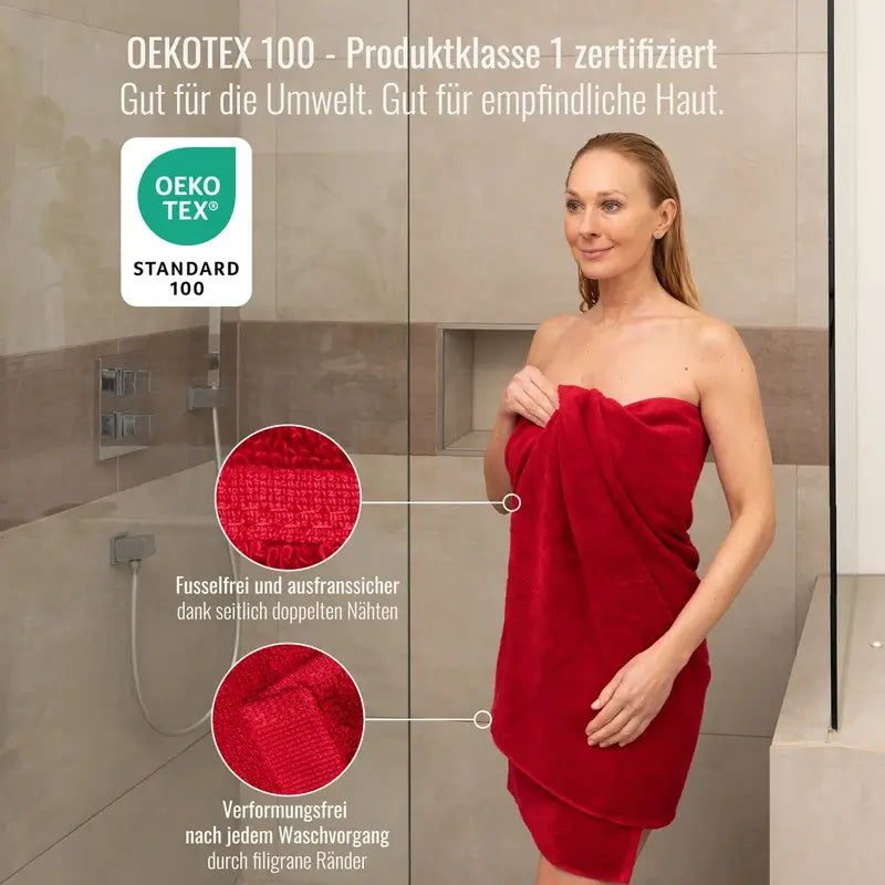 Frau in Dusche mit rotem Bomlins Handtuch aus ägyptischer GIZA Baumwolle, dargestellt mit OEKO-TEX Standard 100 Produktklasse 1 Zertifikat und Detailaufnahmen der doppelt genähten, fusselfreien und formstabilen Ränder