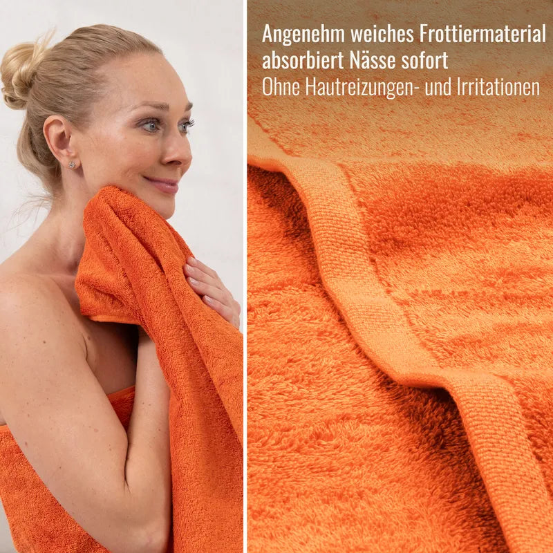 Detailaufnahme orangefarbenes Frottier Handtuch auf der Haut